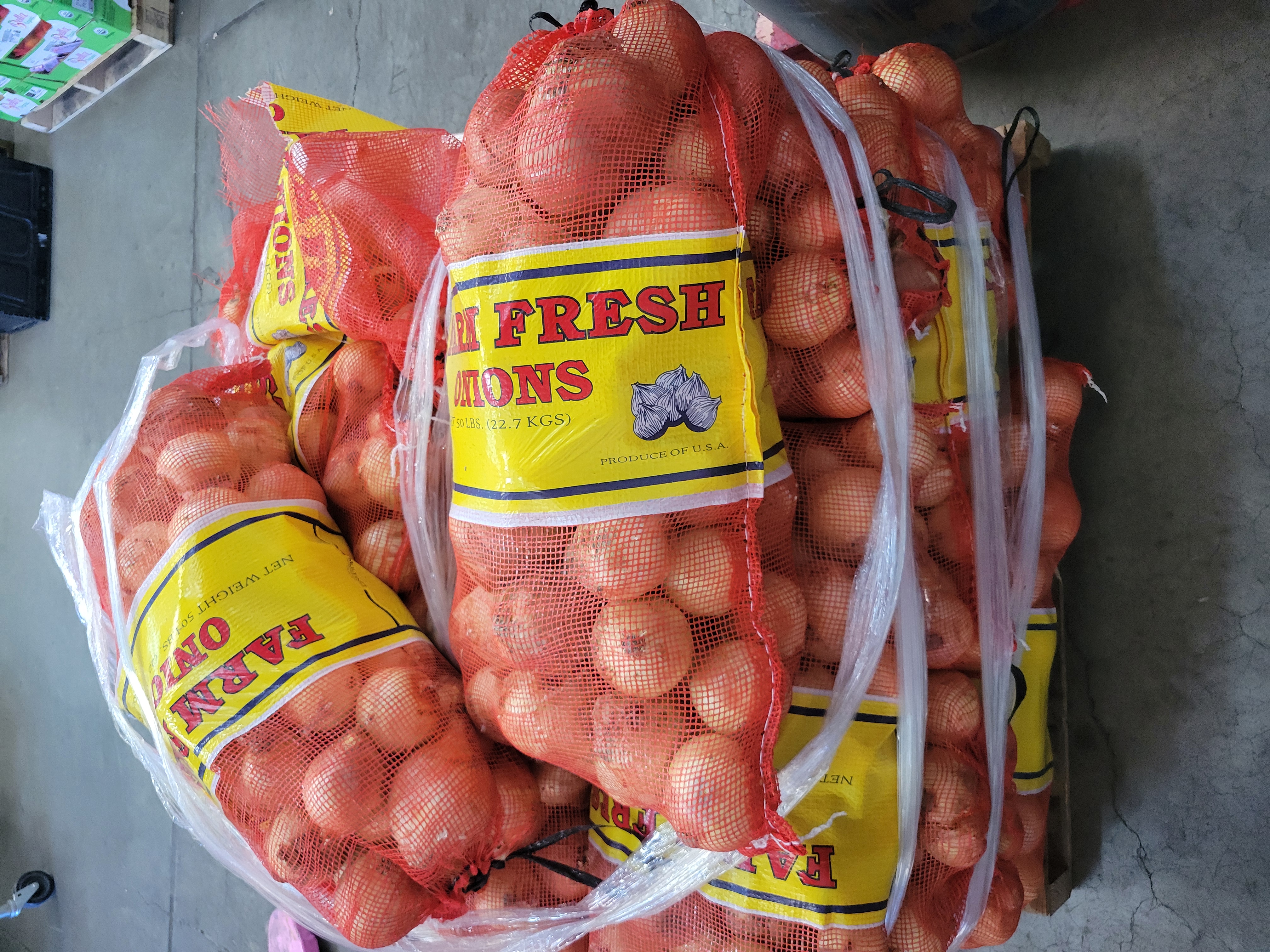 50 pound bags of onions on pallet.